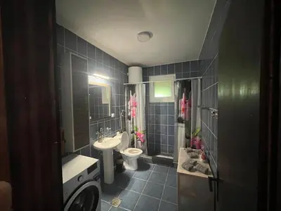 a bathroom with a sink and a toilet and a sink at Apartman FM in Arandjelovac
