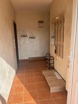 a hallway with a tiled floor with three arrows on the wall at Apartman FM in Arandjelovac