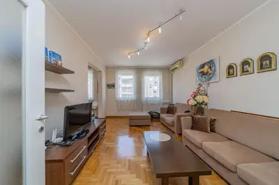 a living room with a couch and a tv at In Arena Belgrade Apartment in Belgrade