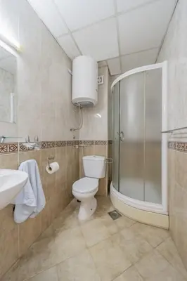 a bathroom with a toilet and a shower and a sink at In Arena Belgrade Apartment in Belgrade