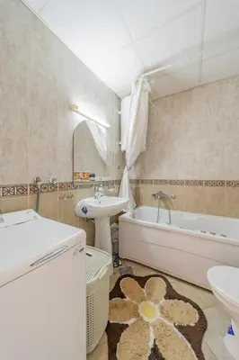 a bathroom with a sink and a tub and a toilet at In Arena Belgrade Apartment in Belgrade