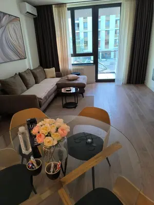 a living room with a couch and a table with flowers on it at Belgrade Waterfront Shine Quartet 3 in Belgrade