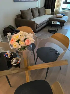 a living room with a glass table with flowers on it at Belgrade Waterfront Shine Quartet 3 in Belgrade