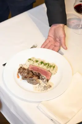 a plate with a piece of food on a table at Pećina Stroga - Bjelica Winery Rooms in Sremski Karlovci