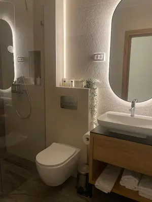 a bathroom with a toilet and a sink and a mirror at Pećina Stroga - Bjelica Winery Rooms in Sremski Karlovci