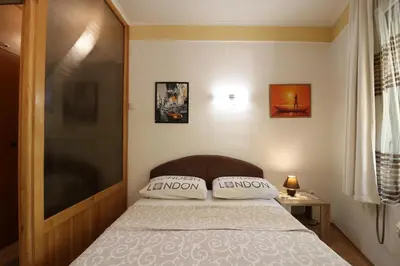 a bedroom with a bed with two pillows on it at Studio Apartman Vojvoda in Belgrade