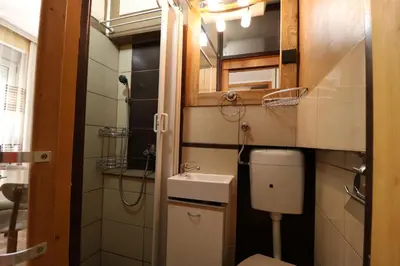 a small bathroom with a toilet and a sink at Studio Apartman Vojvoda in Belgrade