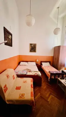 a room with two beds and a desk in it at Apartment Balkan in Belgrade