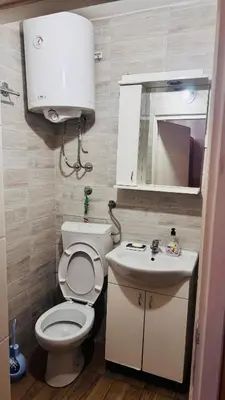 a bathroom with a toilet and a sink and a mirror at Apartment Balkan in Belgrade