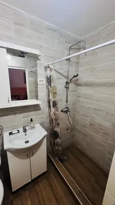 a bathroom with a shower and a sink and a toilet at Apartment Balkan in Belgrade