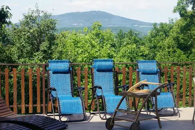 a group of blue chairs sitting on a deck at LipaHill Luxe in Ripanj