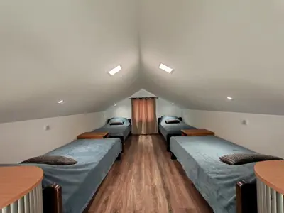 a room with four beds in the attic at LipaHill Luxe in Ripanj