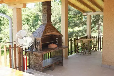 a outdoor grill on a porch with a fan at LipaHill Luxe in Ripanj