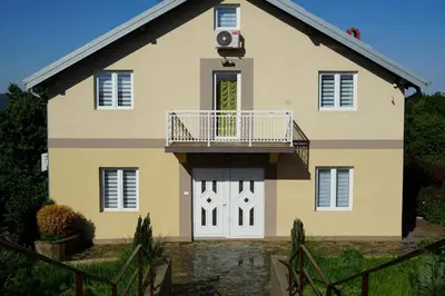 a house with a balcony on the front of it at LipaHill Luxe in Ripanj