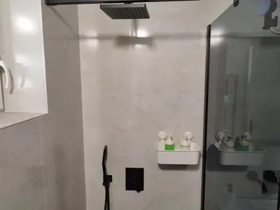 a bathroom with a shower with a glass door at Kostas Apartment in Belgrade