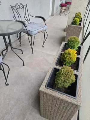 a patio with a table and chairs and potted plants at Kostas Apartment in Belgrade