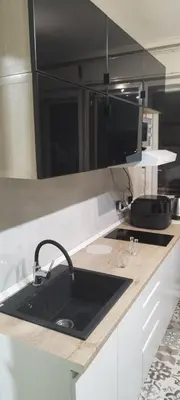 a kitchen with a black sink and a counter at Kostas Apartment in Belgrade