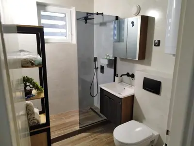 a small bathroom with a toilet and a sink at Kostas Apartment in Belgrade