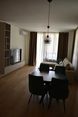 a living room with a table and chairs and a couch at Apartment Luxe Corner BW in Belgrade