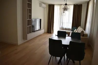 a living room with a table and chairs and a couch at Apartment Luxe Corner BW in Belgrade