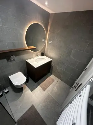 a bathroom with a sink and a toilet and a mirror at Apartment Luxe Corner BW in Belgrade