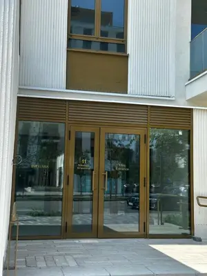 a building with glass doors on the side of it at Apartment Luxe Corner BW in Belgrade