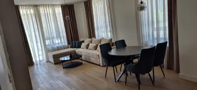 a living room with a couch and a table and chairs at Apartment Luxe Corner BW in Belgrade