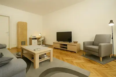 a living room with a television and a couch and a table at Cozy Stay 2 Min from Saint Sava Temple in Belgrade
