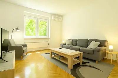a living room with a couch and a coffee table at Cozy Stay 2 Min from Saint Sava Temple in Belgrade