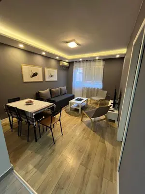 a living room with a couch and a table at Sava square apartment in Belgrade