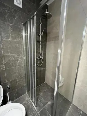 a shower stall in a bathroom with a toilet at Sava square apartment in Belgrade