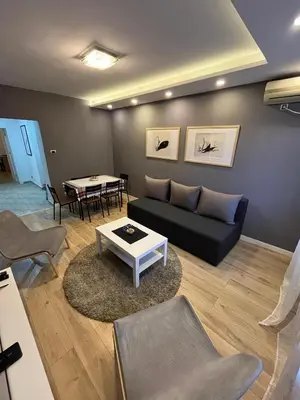 a living room with a couch and a table at Sava square apartment in Belgrade