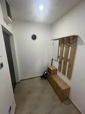 a hallway with a wooden bench in a room at Sava square apartment in Belgrade