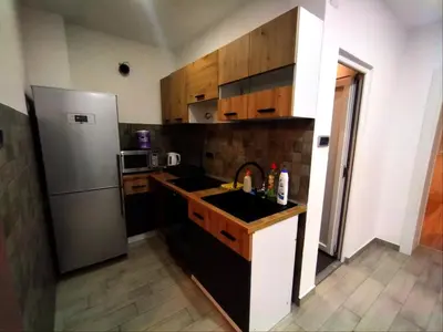 a kitchen with a sink and a refrigerator at Sava square apartment in Belgrade