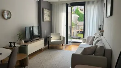 a living room with a couch and a tv at Lux love and family nest next to Skadarlija in Belgrade