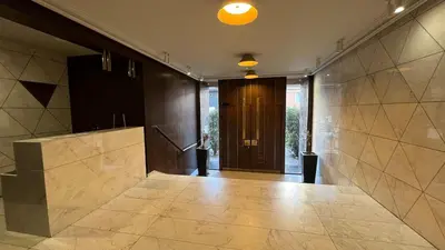 a hallway with a door and a tile floor at Lux love and family nest next to Skadarlija in Belgrade