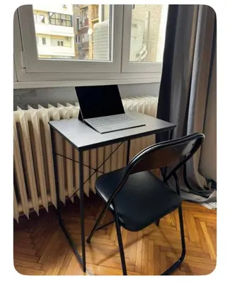 a laptop computer sitting on a table next to a window at Pedestrian Zone Escape in Belgrade