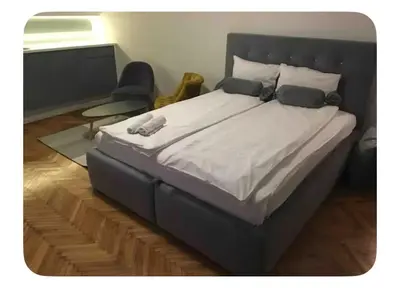 a bedroom with a large bed with a headboard at Pedestrian Zone Escape in Belgrade