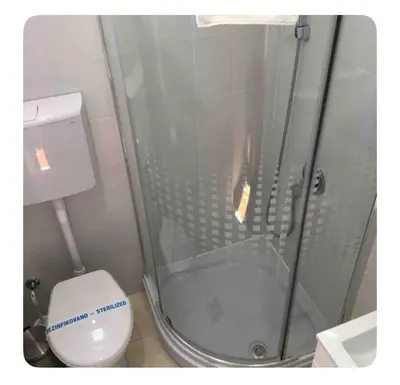 a bathroom with a shower and a white toilet at Pedestrian Zone Escape in Belgrade