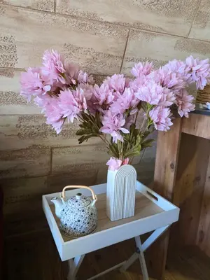 a vase of pink flowers sitting on a table at 3A vikendica Slankamen in Stari Slankamen
