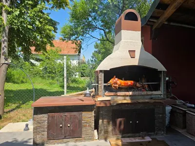 an outdoor oven with a roast chicken in it at 3A vikendica Slankamen in Stari Slankamen