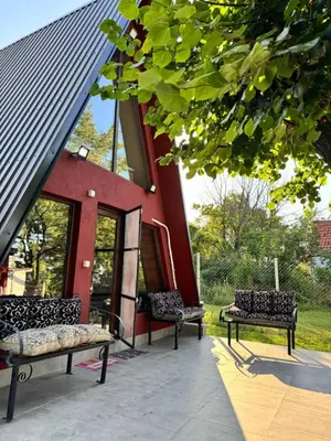 two benches sitting in front of a building at 3A vikendica Slankamen in Stari Slankamen