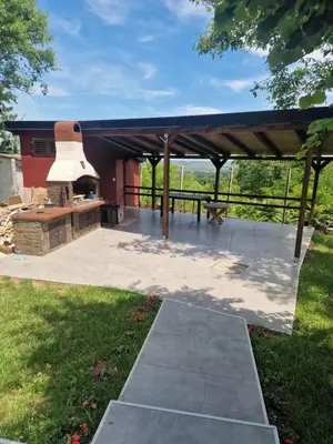 a pavilion with a pizza oven in a yard at 3A vikendica Slankamen in Stari Slankamen