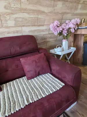 a purple couch sitting in a living room with a table at 3A vikendica Slankamen in Stari Slankamen