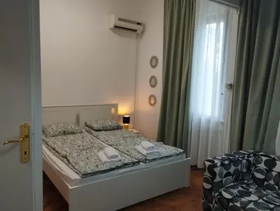 a small bedroom with a bed and a window at Bulevar in Belgrade
