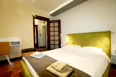 a bedroom with a large bed with towels on it at Studio Intriga in Belgrade