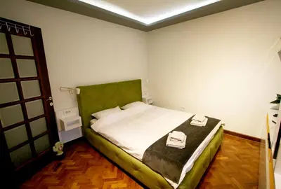 a bedroom with a bed with two towels on it at Studio Intriga in Belgrade