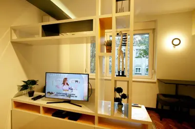 a living room with a tv on a shelf at Studio Intriga in Belgrade