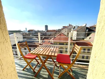a wooden table and two chairs on a balcony at Mirabel in Belgrade