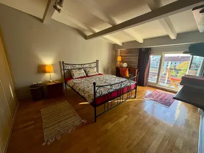 a bedroom with a bed and a large window at Mirabel in Belgrade